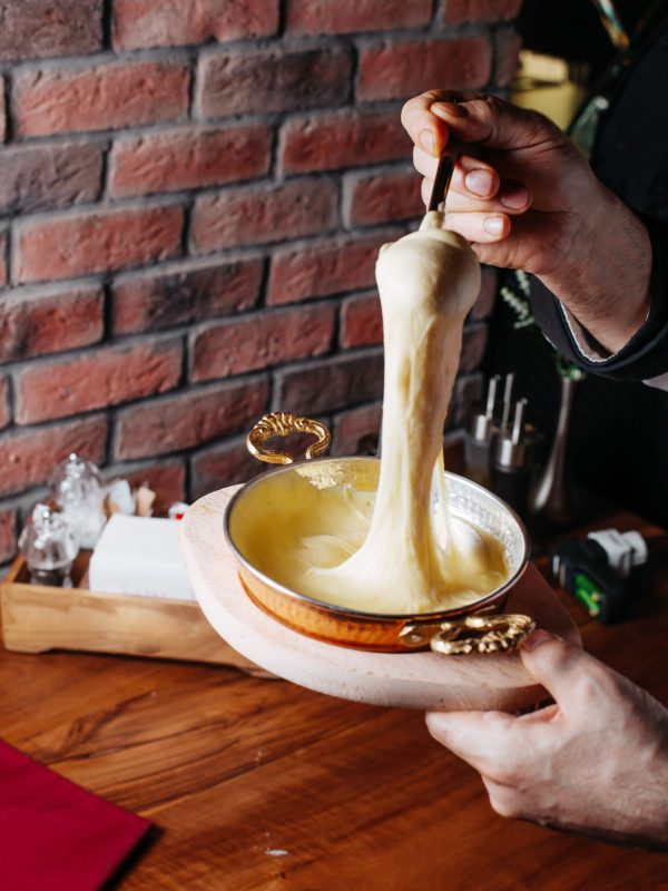 side view of pouring vanilla batter into cake pan